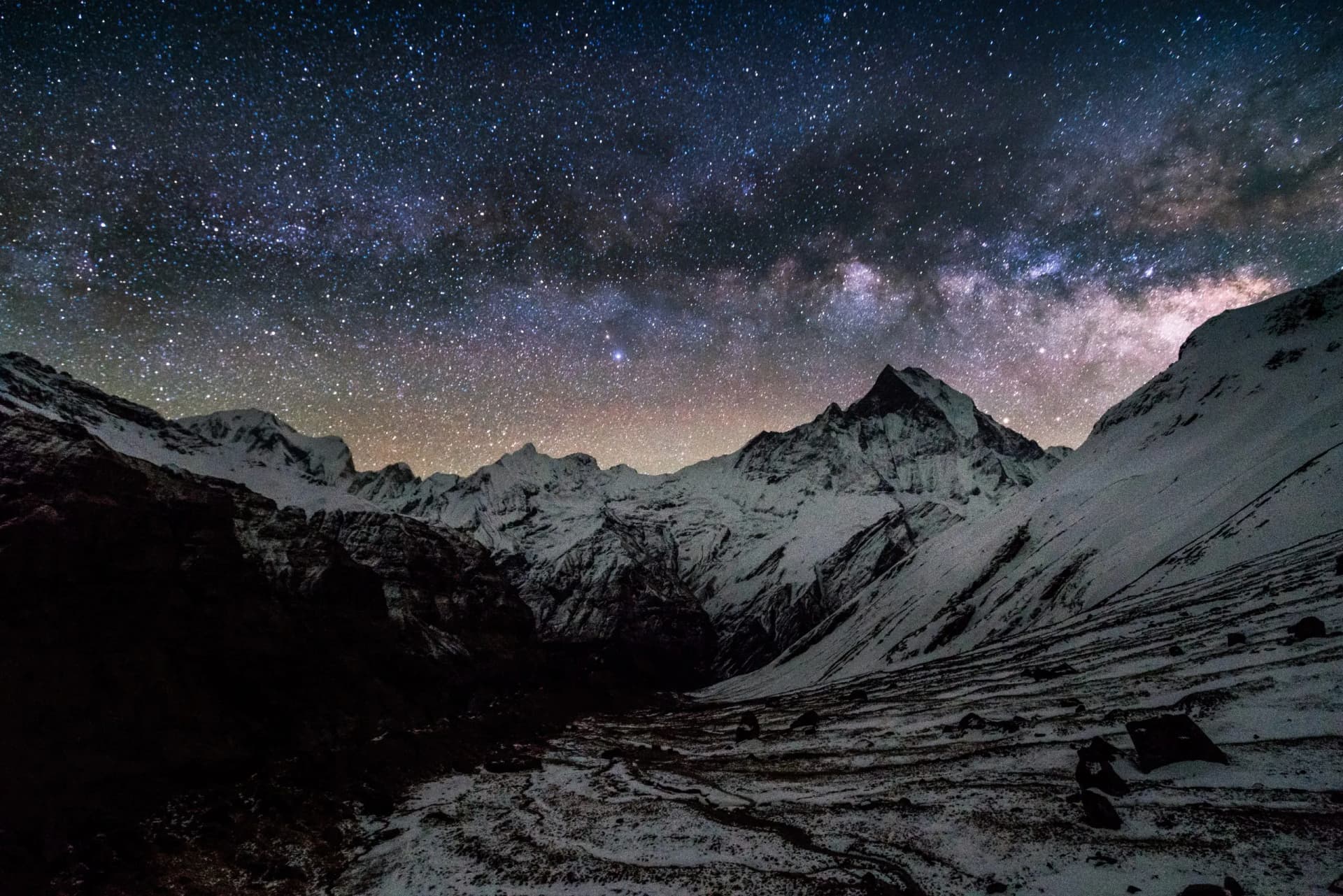 Milky Way over snow-covered Machapuchare Peak on Annapurna Base Camp trekking route.